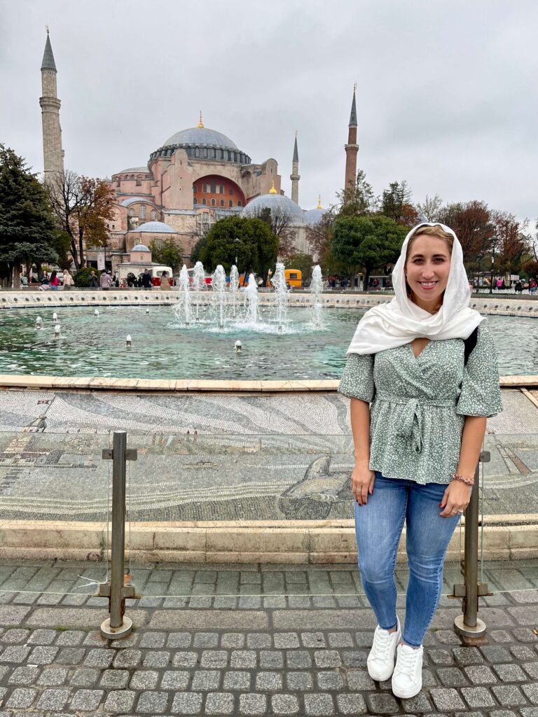 Posing in front of a fountain in front of Hagia Sophia in Istanbul, Turkey