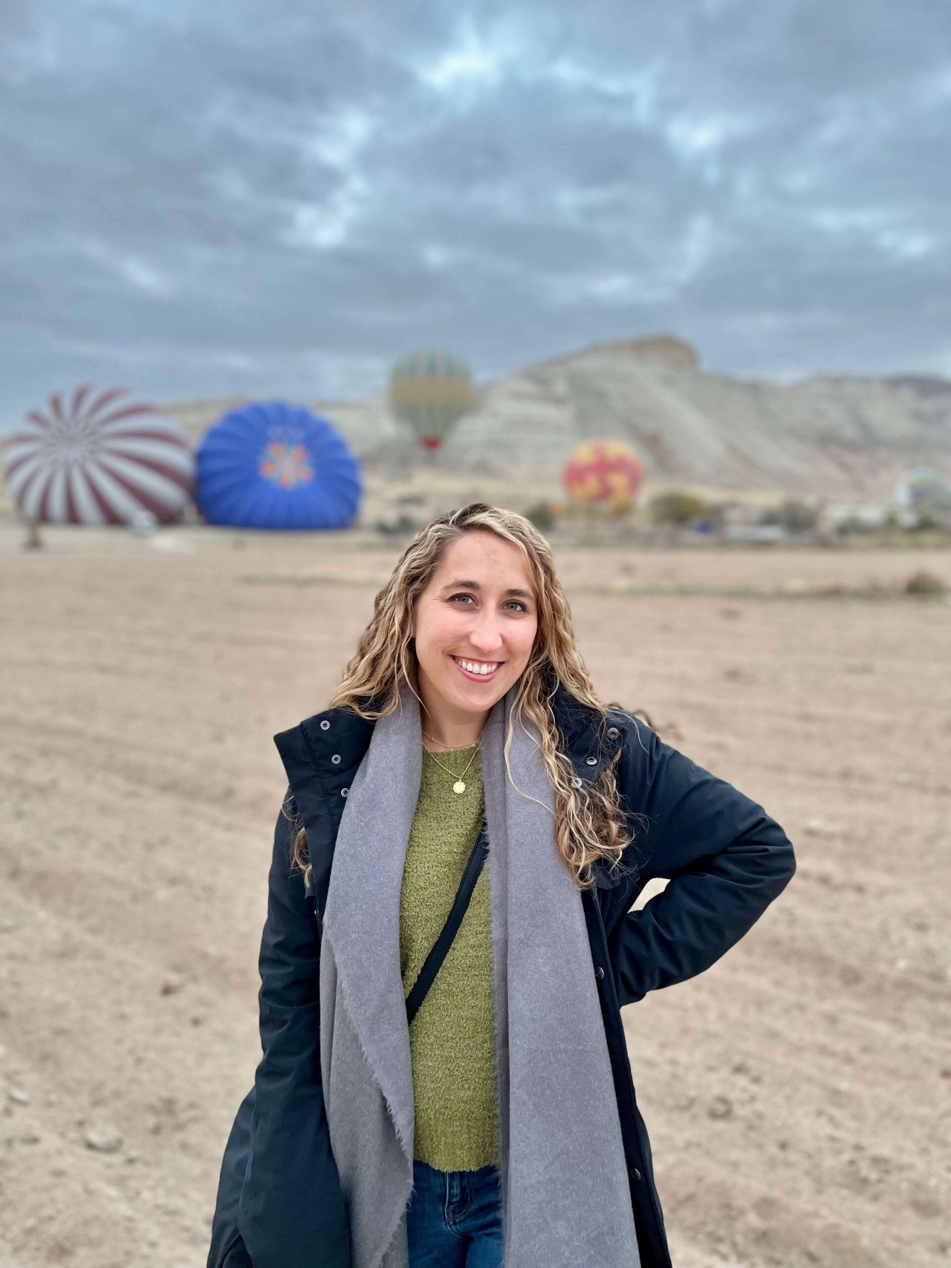Posing in front of hot air balloons starting to fill with air in Cappadocia, Turkey