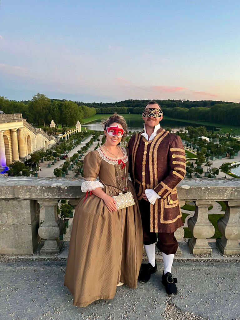 Posing at Le Grand Bal Masqué in the gardens before the event starts.