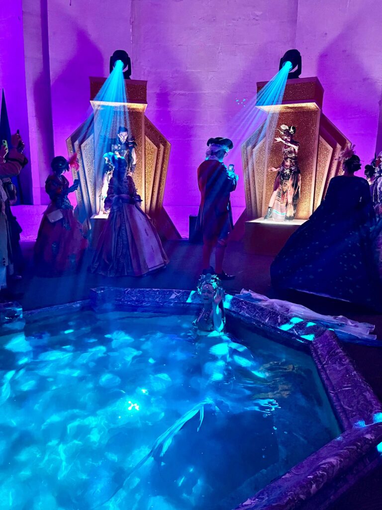 Right inside the Versailles Grand Masked Ball with the welcoming scene and dancers